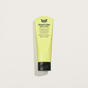 Leif Desert Lime Body Lotion in a pine lime tube, styled with fresh citrus slices and Australian native leaves on a soft background.