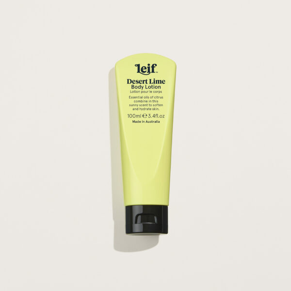 Leif Desert Lime Body Lotion in a pine lime tube, styled with fresh citrus slices and Australian native leaves on a soft background.