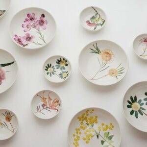 Angus & Celeste Macro Botanics bowl and vase with botanical artwork, milky-speckled glaze, styled on tabletop with native Australian flowers