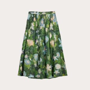 Nancybird Alma Yoke Skirt in Garden print displayed on model among flowers—lightweight cotton voile fabric, green and gold botanical pattern, midi silhouette