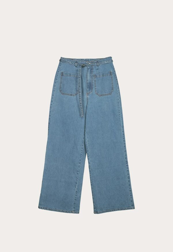 Flat Lay of Nancybird Briar Pants in denim—high‑waist straight‑leg jeans with self‑fabric tie belt, front and back patch pockets, and contrast top stitch detailing in mid wash denim