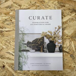 Cover of Curate: Inspiration for an Individual Home by Lynda Gardener and Ali Heath, featuring a serene interior scene that encapsulates the book's emphasis on personalized and timeless design.
