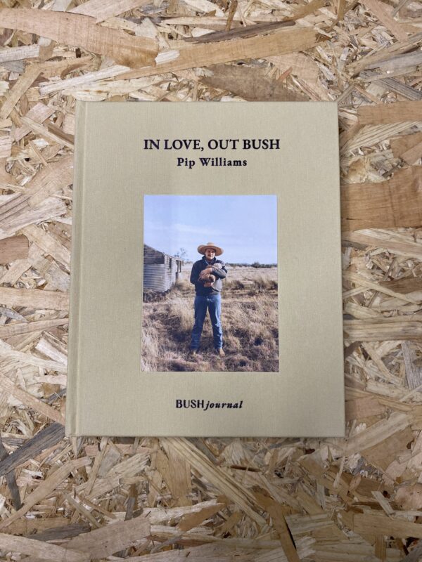 The cover of In Love Out Bush features a striking photograph of a rural Australian landscape, symbolizing the deep connection between people and the land. The cloth-bound hardcover adds a tactile quality, reflecting the book's intimate and heartfelt content.