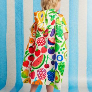 Model wears Halcyon Nights Kids Hooded Towel in Eat The Rainbow print—colourful poncho-style towel with hood, soft cotton fabric and Seeun Park artwork