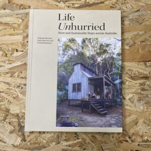 Cover of Life Unhurried: Slow and Sustainable Stays Across Australia, featuring a serene landscape with a minimalist off-grid cabin nestled amidst natural surroundings, reflecting the book's emphasis on slow living and sustainable travel.