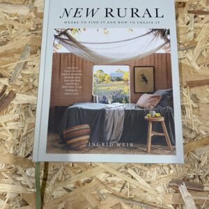 Cover of New Rural: Where to Find It and How to Create It by Ingrid Weir, featuring a serene Australian country home with natural textures and warm tones, set against a backdrop of open landscape.