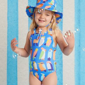 Model wears Halcyon Nights Elastic Strap Bather in Flamin’ Galahs print—one-piece swimsuit with playful pink galahs and colourful elastic straps for kids