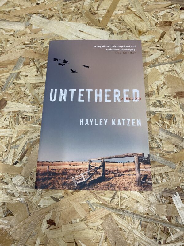 Cover of Untethered: A Memoir by Hayley Katzen, featuring a solitary figure standing amidst the vast Australian outback, symbolizing the journey of self-discovery and the search for belonging.