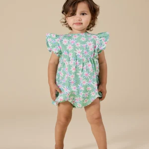 Baby wearing Goldie & Ace Daisy Patch Lani Romper in moss green, with frill sleeves and leg snaps.