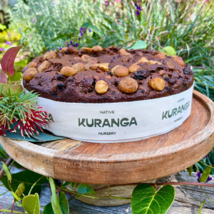 Kuranga Native Christmas Cake with Wattle Seed, Lemon Myrtle, and Macadamia, topped with cherries and pecans — Australian bush-inspired Christmas dessert.